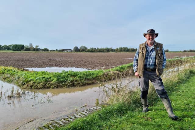 Stewart Peltell of the Wainfleet Flood Advisory Group next to dykes still full on Monday.