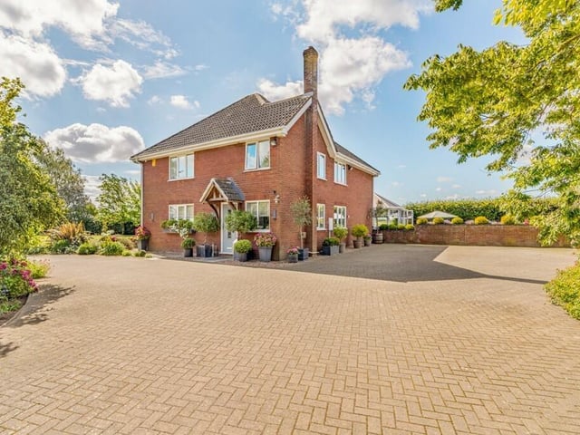 The side and rear of the property, with boot room entrance.