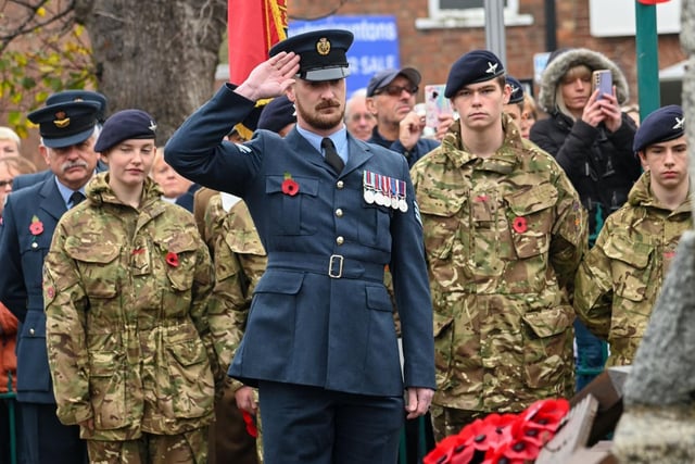Military personnel pay their respects at the war memorial in Kirton.