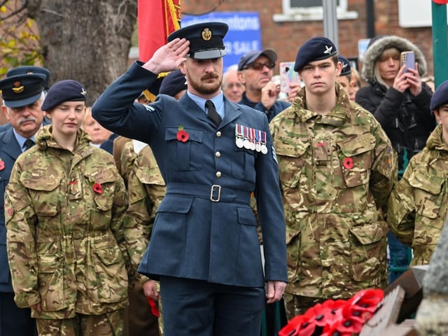 Military personnel pay their respects at the war memorial in Kirton.