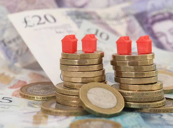 EMBARGOED TO 0001 TUESDAY FEBRUARY 28 File photo dated 12/09/18 of model houses on a pile of coins and bank notes, as House sellers are shaving just over £14,000 off their original asking prices typically to achieve a sale, according to a property website. Zoopla analysed agreed sales, looking at the differences between original asking prices and eventual selling prices. Sales where discounts had not been made were also included. Issue date: Tuesday February 28, 2023.