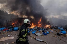 Firefighters try to extinguish a fire after Russian shelling in Kyiv, Ukraine. (Photo by Chris McGrath/Getty Images)