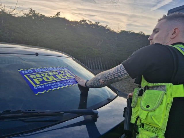 A 'Seized by Police' sticker is placed across the back window of a vehicle which was decided to be too dangerous to be moved by occupants.