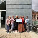 Rolling Scones committee members presented the money to theatre manager Tracey Mackenzie (centre). Image Paula Burrett