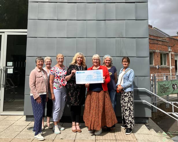 Rolling Scones committee members presented the money to theatre manager Tracey Mackenzie (centre). Image Paula Burrett