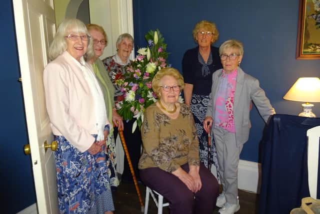 Committee members at the 60th anniversary event (standing, from left) Mary Snowden, Cassie Henderson, Audrey Chatterton, Mary McKinder, and Maureen Dales, with demonstrator Heather Shaw.