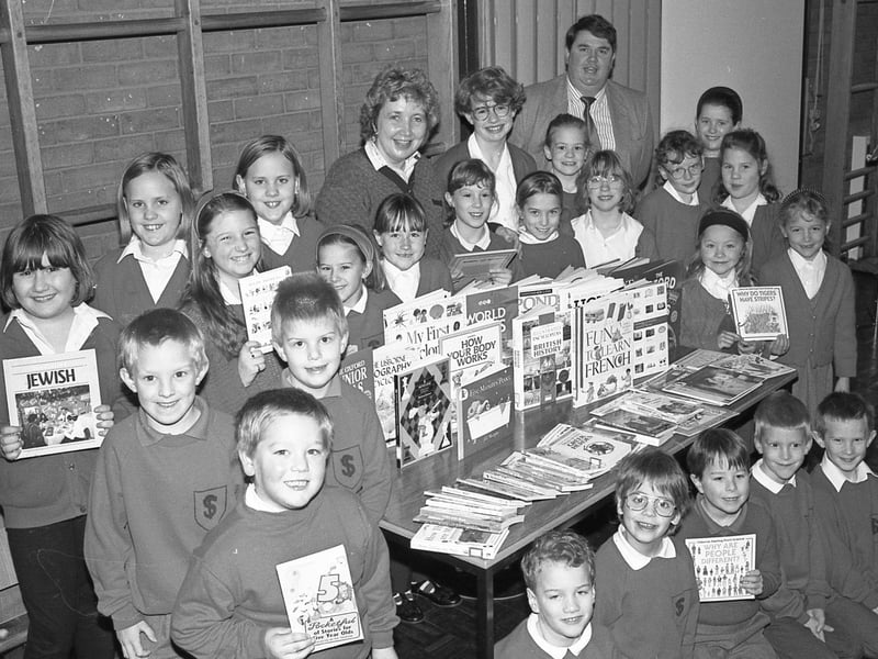Pupils at St Thomas', Boston, receiving a £200 donation of books from WH Smith as part of a voucher scheme run by the retailer. Pictured with the pupils are Jane Keightley, Boston WH Smith's school and college advisor, and headteacher Chris Bell.
