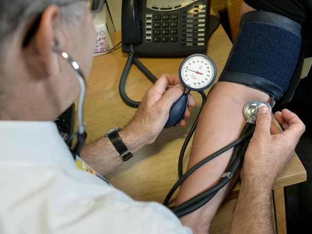 A GP checking a patient's blood pressure. Image for illustration only.