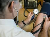 A GP checking a patient's blood pressure. Image for illustration only.