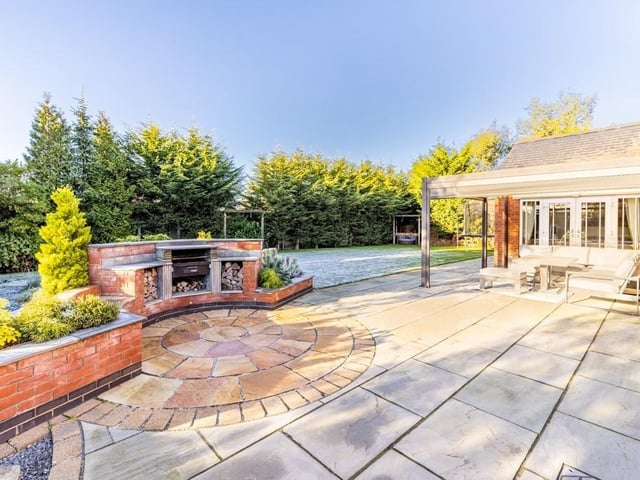 The patio, outdoor barbecue and covered seating area.
