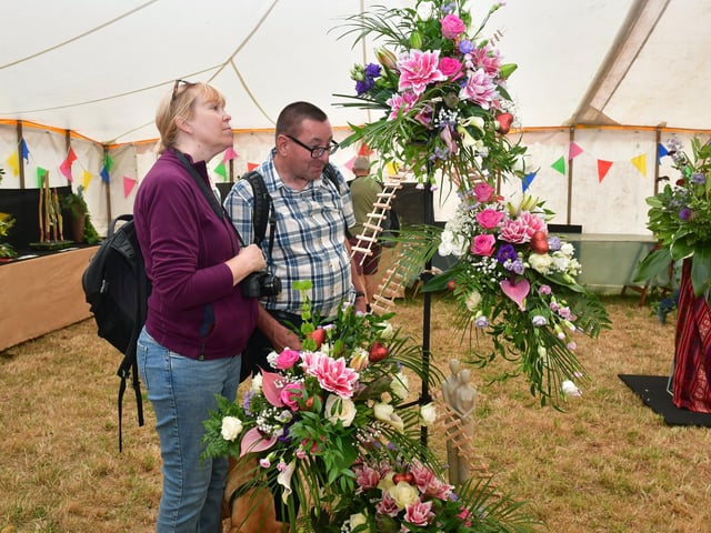 Neil and Helen Smith of North Lincolnshire inspect a winning flower arrangement by Andrew Key of Heckington.