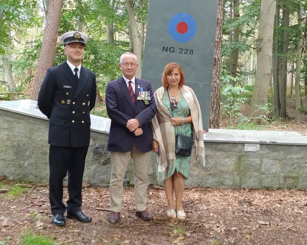 Simon Elmer (centre) at the memorial in Poland with friend Anna Stalmierska and Lieutenant Robert Dusza.