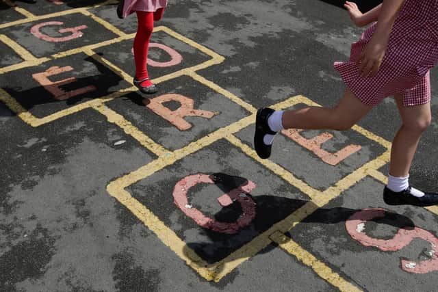 Children at St. George's C of E Primary School in Stockport,play hop scotch during playtime.