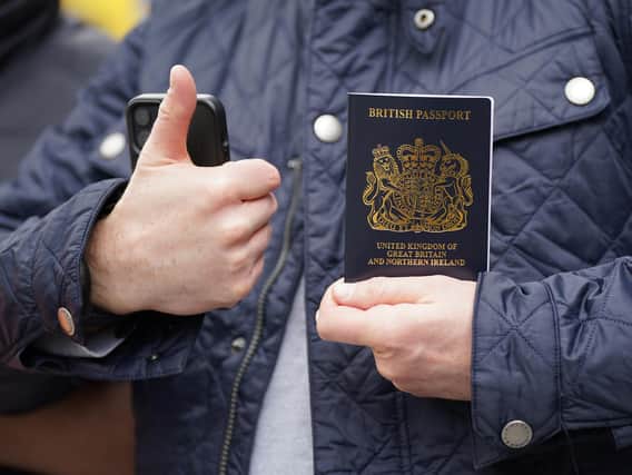 Alex Sladen holding his new passport in front of members of the PCS union on the picket line outside the Passport Office in east London, as more than 1,000 members of the Public and Commercial Services (PCS) union working in passport offices in England, Scotland and Wales begin a five week strike as part of the civil service dispute. Picture date: Monday April 3, 2023.