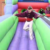 L-R Maddie Musgrove 9 and Tillie Musgrove 9 of Scopwick take on the bungee run inflatable at Metheringham Fayre and feast.
