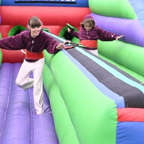 L-R Maddie Musgrove 9 and Tillie Musgrove 9 of Scopwick take on the bungee run inflatable at Metheringham Fayre and feast.