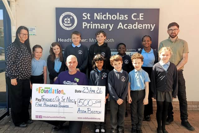Asda's Stephen Bromby making the donation to Friends of St Nics at St Nicholas CofE Primary Academy, with Laura MacRae, chairman of the group, on the left.