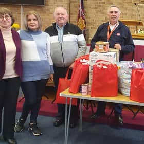 John Holmes (third from left) from the Hull4Ukraine charity, receives the supplies from Terence Carpenter of the Market Rasen Salvation Army and Ukrainian refugees Liliya, Olena and Lyudmila.