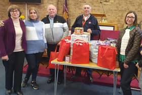 John Holmes (third from left) from the Hull4Ukraine charity, receives the supplies from Terence Carpenter of the Market Rasen Salvation Army and Ukrainian refugees Liliya, Olena and Lyudmila.