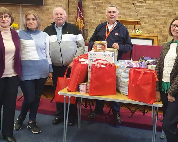 John Holmes (third from left) from the Hull4Ukraine charity, receives the supplies from Terence Carpenter of the Market Rasen Salvation Army and Ukrainian refugees Liliya, Olena and Lyudmila.