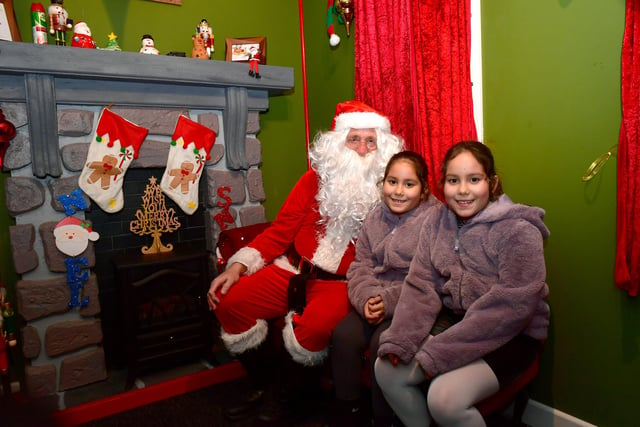 Father Christmas in Pescod Square, pictured with Mara Gomes, 9, and Eva Gomes, 9, of Boston.