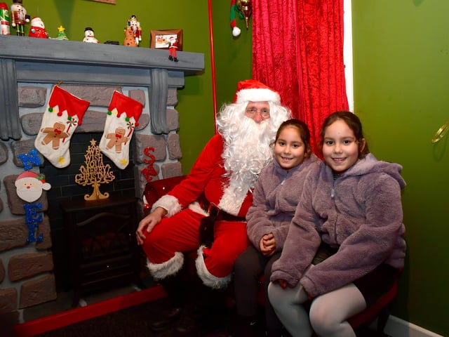 Father Christmas in Pescod Square, pictured with Mara Gomes, 9, and Eva Gomes, 9, of Boston.