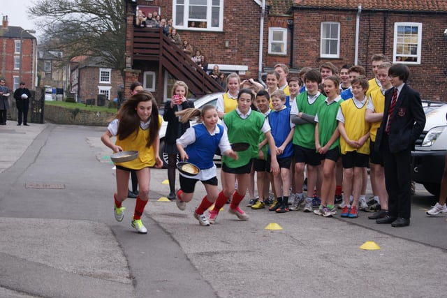 A scene from Caistor Grammar School's annual pancake race of 2013. From left, Lucy Wilson (Hansard), Olivia Smith (Ayscough) and Jessica Jex start the race.