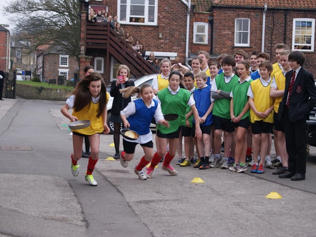 A scene from Caistor Grammar School's annual pancake race of 2013. From left, Lucy Wilson (Hansard), Olivia Smith (Ayscough) and Jessica Jex start the race.