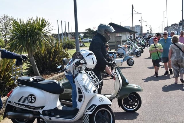 Scooters lined up along the seafront for a  custom show.