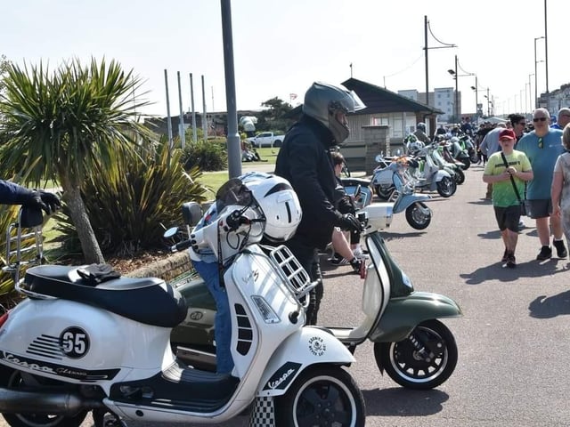 Scooters lined up along the seafront for a custom show.