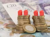 EMBARGOED TO 0001 TUESDAY FEBRUARY 28 File photo dated 12/09/18 of model houses on a pile of coins and bank notes, as House sellers are shaving just over £14,000 off their original asking prices typically to achieve a sale, according to a property website. Zoopla analysed agreed sales, looking at the differences between original asking prices and eventual selling prices. Sales where discounts had not been made were also included. Issue date: Tuesday February 28, 2023.