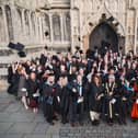 Mortarboards take flight outside St Botolph's Church at Boston College's Higher Education Graduation Ceremony.
