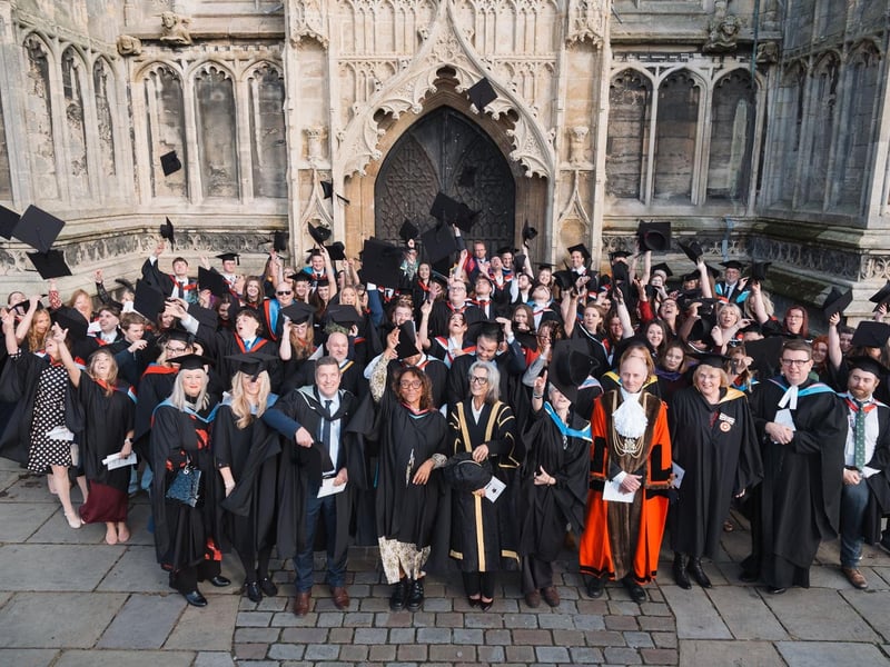 Mortarboards take flight outside St Botolph's Church at Boston College's Higher Education Graduation Ceremony.