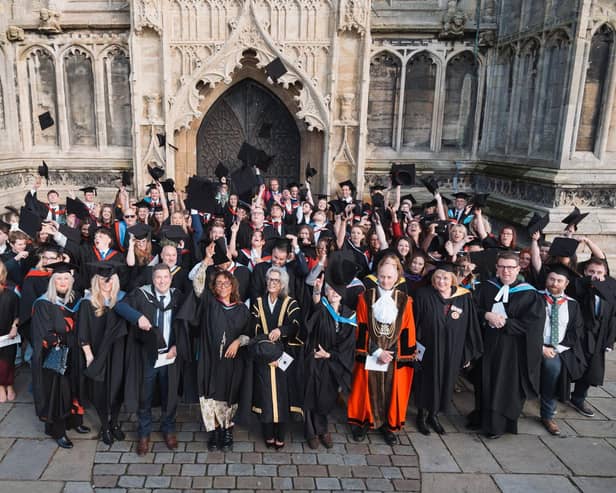Mortarboards take flight outside St Botolph's Church at Boston College's Higher Education Graduation Ceremony.
