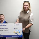 Jonah presented the money to St Barnabas Fundraising Officer Ellie Carter