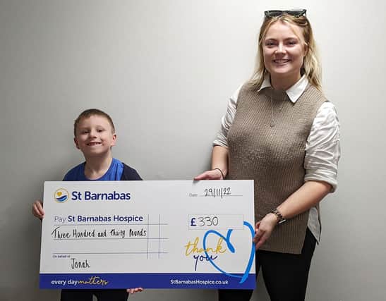 Jonah presented the money to St Barnabas Fundraising Officer Ellie Carter