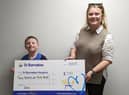 Jonah presented the money to St Barnabas Fundraising Officer Ellie Carter