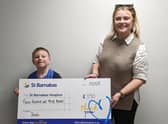 Jonah presented the money to St Barnabas Fundraising Officer Ellie Carter