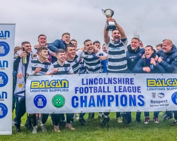 Louth Town's players celebrate the league and cup double.