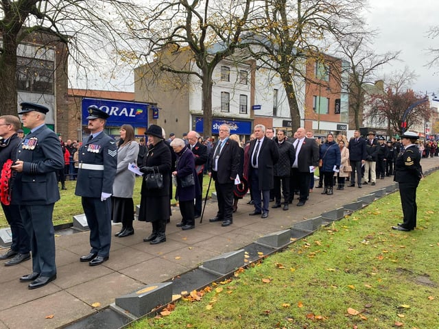 Military personnel, local dignitaries and members of the public line up at Boston's Memorial Gardens.