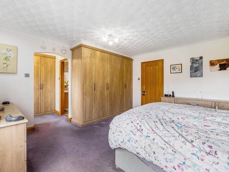 Another angle on the principal bedroom, showing the entrance to the dressing room and en suite.