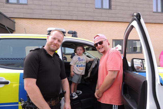 Freddie Carey, two, of Ruskington, has a ride in a police car, with dad Tom Carey and Sgt Stuart Mumby-Croft.