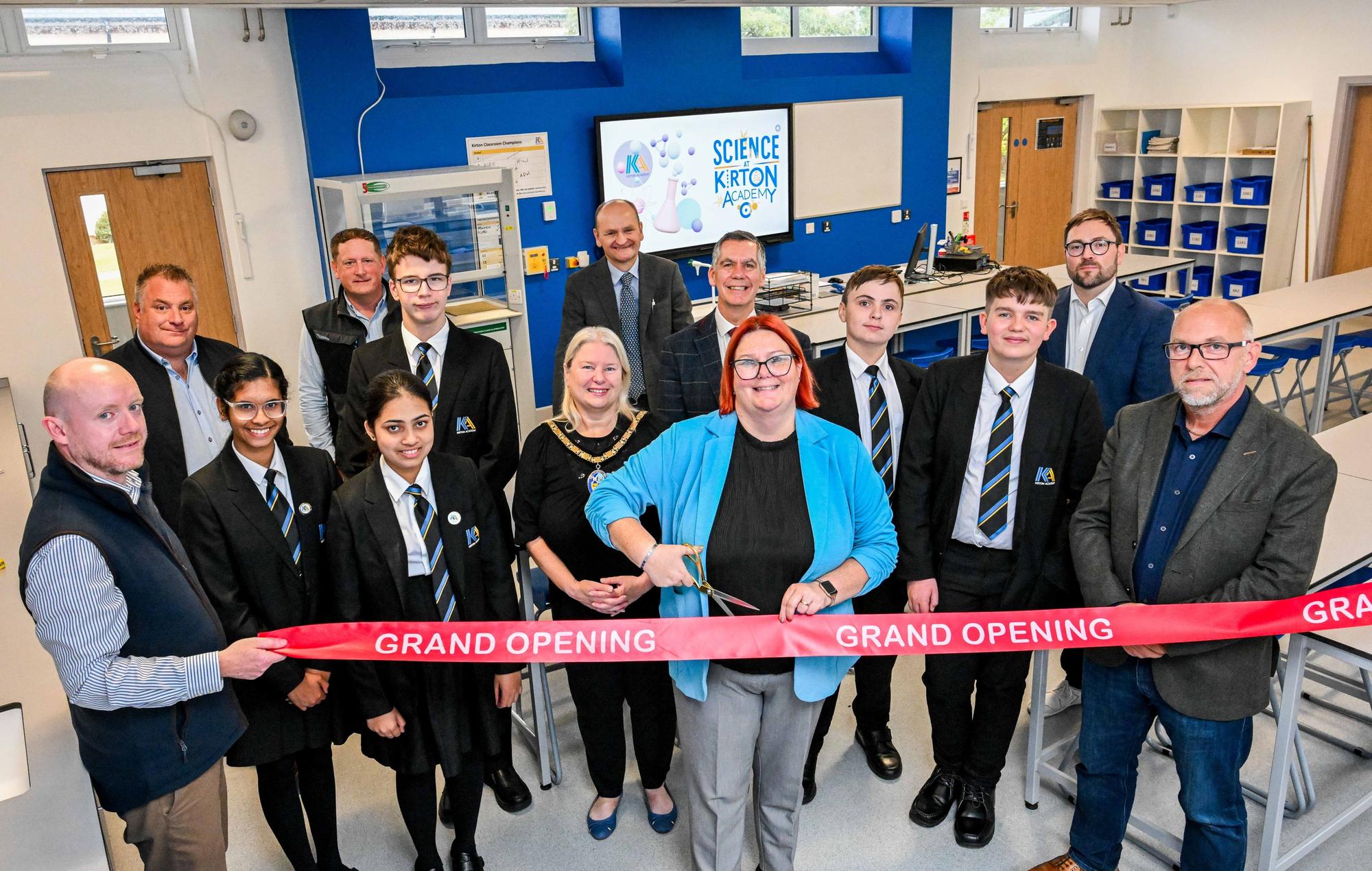 Principal Mrs Ricketts cuts the ribbon to formally unveil the academy’s refurbishment. She is joined in one of the refurbished science laboratories by students (left to right) Bilha Alias, Diya George, Christopher Bilverstone, Kaden Armstrong and Lucas Delacour; the Mayor Cllr Hazel Fox; LGAT’s Chief Executive Officer Martin Brown (back, centre) and Assistant Director of Education at North Lincolnshire Council Paul Tinsley (fifth right). Also pictured (left to right) are Andy Staunton from Richard Eves Architects; Steve Henderson, Synergi Energy Systems; Andrew Mathieson, Cube3; Luke Scorer from electrical consultants Aptus Ltd; and Sean Hunter, Cube 3.