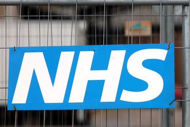 An NHS sign on a fence at Broomfield Hospital in Chelmsford.