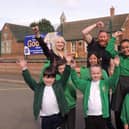 Executive headteacher Sophie Foston, chairman of governors Matt Timings and assistant headteacher Sarah Gray celebrate with pupils after their latest 'Good' Ofsted rating.