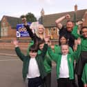 Executive headteacher Sophie Foston, chairman of governors Matt Timings and assistant headteacher Sarah Gray celebrate with pupils after their latest 'Good' Ofsted rating.