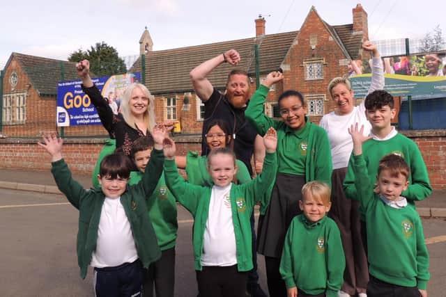 Executive headteacher Sophie Foston, chairman of governors Matt Timings and assistant headteacher Sarah Gray celebrate with pupils after their latest 'Good' Ofsted rating.