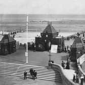Locals and tourists take in the fresh air on the The Pier at Skegness, circa 1900.