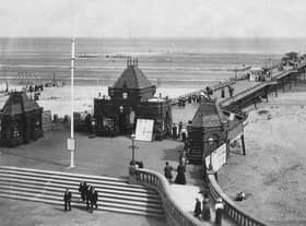 Locals and tourists take in the fresh air on the The Pier at Skegness, circa 1900.