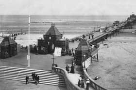 Locals and tourists take in the fresh air on the The Pier at Skegness, circa 1900.